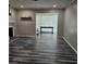 Spacious living room with wood-look floors, a fireplace, and a large opening to an adjacent room at 108 Countryside Se Pl, Smyrna, GA 30080