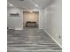 Open living room with wood-look floors, neutral wall color, and large opening to an adjacent room at 108 Countryside Se Pl, Smyrna, GA 30080
