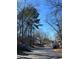 Street view of neighborhood with mature trees and sidewalks and community amenities at 108 Countryside Se Pl, Smyrna, GA 30080