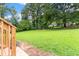 Spacious backyard with lush green grass and mature trees at 1326 Stella Sw Cir, Mableton, GA 30126