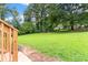 Large backyard with healthy green grass and mature shade trees at 1326 Stella Sw Cir, Mableton, GA 30126