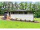 View of the back of the house with covered porch, and an ample manicured lawn at 1326 Stella Sw Cir, Mableton, GA 30126