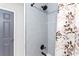 Updated bathroom featuring sleek tile, modern fixtures and a decorative shower curtain at 1326 Stella Sw Cir, Mableton, GA 30126