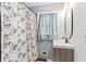 Bathroom with tiled walls, cabinet sink, shower with curtain, and updated fixtures at 1326 Stella Sw Cir, Mableton, GA 30126