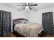 Cozy bedroom with hardwood floors, natural light, a ceiling fan, and modern dark curtains at 1326 Stella Sw Cir, Mableton, GA 30126