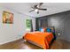 Bedroom with hardwood floors, accent wall, ceiling fan, and natural light from the window at 1326 Stella Sw Cir, Mableton, GA 30126