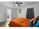Bedroom with hardwood floors, accent wall, ceiling fan, and natural light from the window at 1326 Stella Sw Cir, Mableton, GA 30126