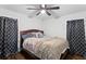 Spacious bedroom with hardwood floors, a ceiling fan, and patterned curtains for privacy at 1326 Stella Sw Cir, Mableton, GA 30126