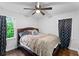 Cozy bedroom with hardwood floors, natural light, a ceiling fan, and modern dark curtains at 1326 Stella Sw Cir, Mableton, GA 30126