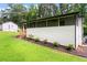 Rear exterior of home with screened porch and landscaped yard at 1326 Stella Sw Cir, Mableton, GA 30126