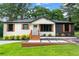Lovely single-story home with a green lawn, newly painted exterior and inviting front entrance at 1326 Stella Sw Cir, Mableton, GA 30126