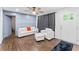 Bright living room featuring hardwood floors, stylish decor, and a cozy seating area at 1326 Stella Sw Cir, Mableton, GA 30126
