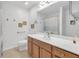 Well-lit bathroom featuring a single sink vanity, a walk-in shower, and neutral tile flooring at 1402 Silver Summit Se Dr, Conyers, GA 30094