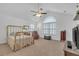 Spacious bedroom with vaulted ceilings, plush carpet, a ceiling fan, and lots of natural light from large windows at 1402 Silver Summit Se Dr, Conyers, GA 30094