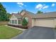 This home features a well-maintained lawn, attached garage, and beautiful shrubbery along the front of the house at 1402 Silver Summit Se Dr, Conyers, GA 30094