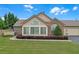 Charming single-story home with a lush green lawn, complemented by manicured landscaping and a brick facade at 1402 Silver Summit Se Dr, Conyers, GA 30094