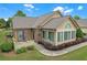Inviting home exterior with manicured landscaping, charming brick accents, and a cozy outdoor seating area at 1402 Silver Summit Se Dr, Conyers, GA 30094