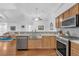 Open-concept kitchen featuring a large stainless steel sink and a full suite of stainless steel appliances at 1402 Silver Summit Se Dr, Conyers, GA 30094