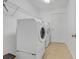 Functional laundry room equipped with modern washer and dryer units plus convenient storage shelving at 1402 Silver Summit Se Dr, Conyers, GA 30094