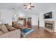 Open-concept living room with vaulted ceiling, a fireplace, and hardwood floors for seamless entertaining and relaxation at 1402 Silver Summit Se Dr, Conyers, GA 30094