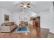 Bright living area featuring hardwood floors, a vaulted ceiling, and an open layout that connects to the kitchen and dining area at 1402 Silver Summit Se Dr, Conyers, GA 30094