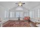 Sun-filled living area featuring hardwood floors, vaulted ceiling, and multiple windows creating a warm and inviting space at 1402 Silver Summit Se Dr, Conyers, GA 30094