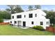 Modern home boasts a spacious backyard, patio area, and privacy fence at 2220 Meadowvale Ne Dr, Atlanta, GA 30345