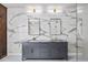 Modern bathroom featuring double vanity with marble countertop and decorative marble wall at 2220 Meadowvale Ne Dr, Atlanta, GA 30345