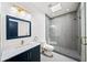Contemporary bathroom featuring modern fixtures, a walk-in shower with gray tile, and an eye-catching mosaic shower floor at 2220 Meadowvale Ne Dr, Atlanta, GA 30345