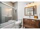 Bathroom featuring a shower and tub combination, a modern vanity with ample storage, and stylish lighting at 2220 Meadowvale Ne Dr, Atlanta, GA 30345