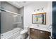 Bathroom featuring a shower and tub combination, a modern vanity with ample storage, and stylish lighting at 2220 Meadowvale Ne Dr, Atlanta, GA 30345