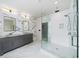 Luxurious bathroom featuring a glass walk-in shower and double sink vanity with marble countertops at 2220 Meadowvale Ne Dr, Atlanta, GA 30345