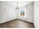 An empty bedroom with a unique light fixture and a large window providing an abundance of natural light at 2220 Meadowvale Ne Dr, Atlanta, GA 30345
