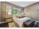 Comfortable bedroom featuring wallpaper, dark floors, and a bench at 2220 Meadowvale Ne Dr, Atlanta, GA 30345