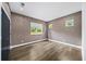 Bedroom featuring elegant wallpaper, hardwood floors, recessed lighting, and three windows offering natural light at 2220 Meadowvale Ne Dr, Atlanta, GA 30345