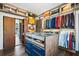 Walk-in closet featuring custom closet organizers, center island, and wood floors at 2220 Meadowvale Ne Dr, Atlanta, GA 30345