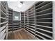 Spacious walk-in closet with custom shelving and hardwood floors at 2220 Meadowvale Ne Dr, Atlanta, GA 30345