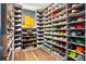 Walk-in closet with custom shelving filled with shoes and Louis Vuitton boxes at 2220 Meadowvale Ne Dr, Atlanta, GA 30345