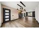 Open-concept living and dining area featuring modern lighting and wine storage at 2220 Meadowvale Ne Dr, Atlanta, GA 30345