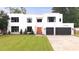 Stunning modern home featuring an attached two-car garage, manicured lawn and eye-catching orange front door at 2220 Meadowvale Ne Dr, Atlanta, GA 30345