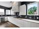 Modern kitchen with black tile backsplash, sleek cabinetry, and stainless steel appliances at 2220 Meadowvale Ne Dr, Atlanta, GA 30345