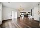 Bright living room with modern light fixture, hardwood floors, and view into open kitchen at 2220 Meadowvale Ne Dr, Atlanta, GA 30345