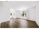 Spacious living room featuring hardwood flooring, large windows with coverings allowing natural light to fill the space at 2220 Meadowvale Ne Dr, Atlanta, GA 30345