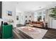 Bright living room with hardwood floors, large windows providing natural light and a stylish leather sofa at 2220 Meadowvale Ne Dr, Atlanta, GA 30345