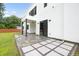 Back patio with tile and stone design, ceiling fan, and sliding glass door at 2220 Meadowvale Ne Dr, Atlanta, GA 30345