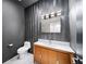 Stylish powder room features wood-look accent wall, floating vanity, and modern fixtures at 2220 Meadowvale Ne Dr, Atlanta, GA 30345