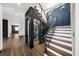 Staircase featuring unique design with glass enclosed wine cellar, and hardwood floors at 2220 Meadowvale Ne Dr, Atlanta, GA 30345
