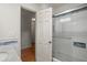 Modern bathroom with glass enclosed shower with tile surround and sleek fixtures, leading to the hallway at 3013 Huntshire, Doraville, GA 30340