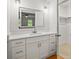 Bathroom featuring white cabinets, quartz counters, a large mirror, and modern lighting at 3013 Huntshire, Doraville, GA 30340