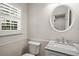 Bathroom featuring granite countertops, round mirror, and a window with shutters at 3013 Huntshire, Doraville, GA 30340